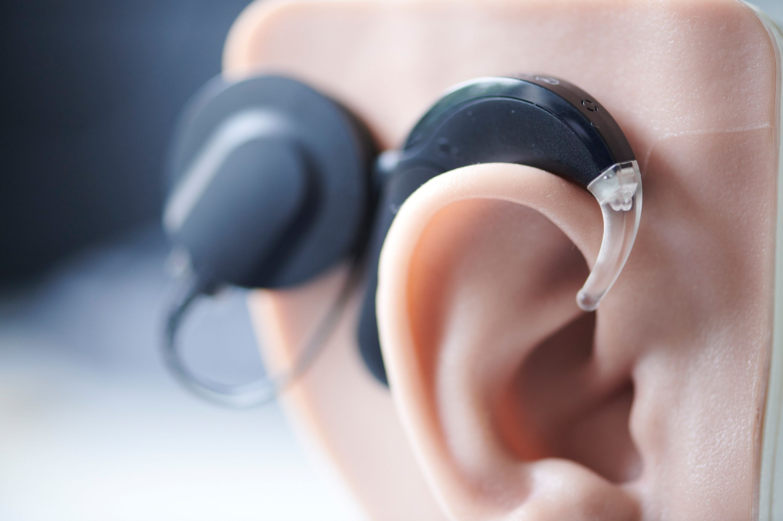 Close-up of a hearing aid on a model ear