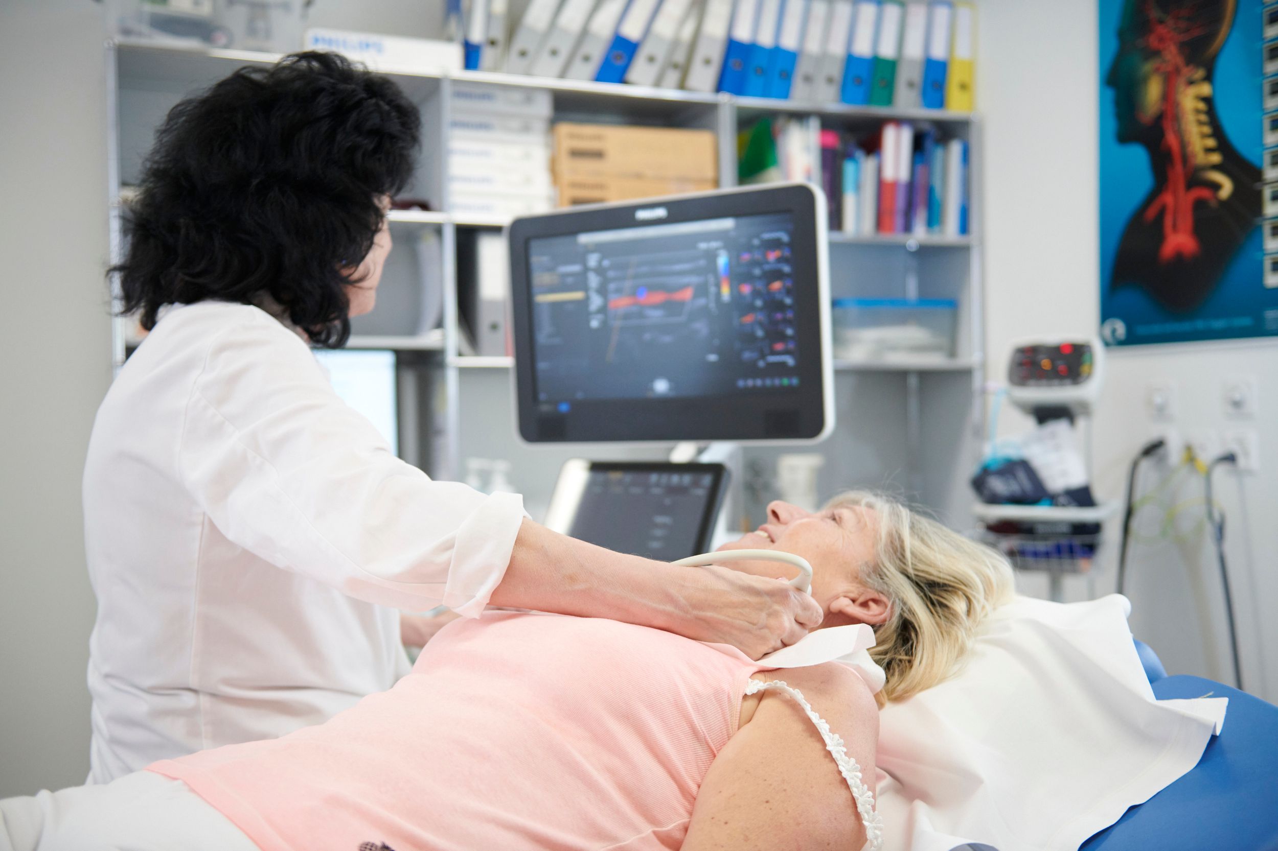 Doctor performs neurovascular ultrasound on patient