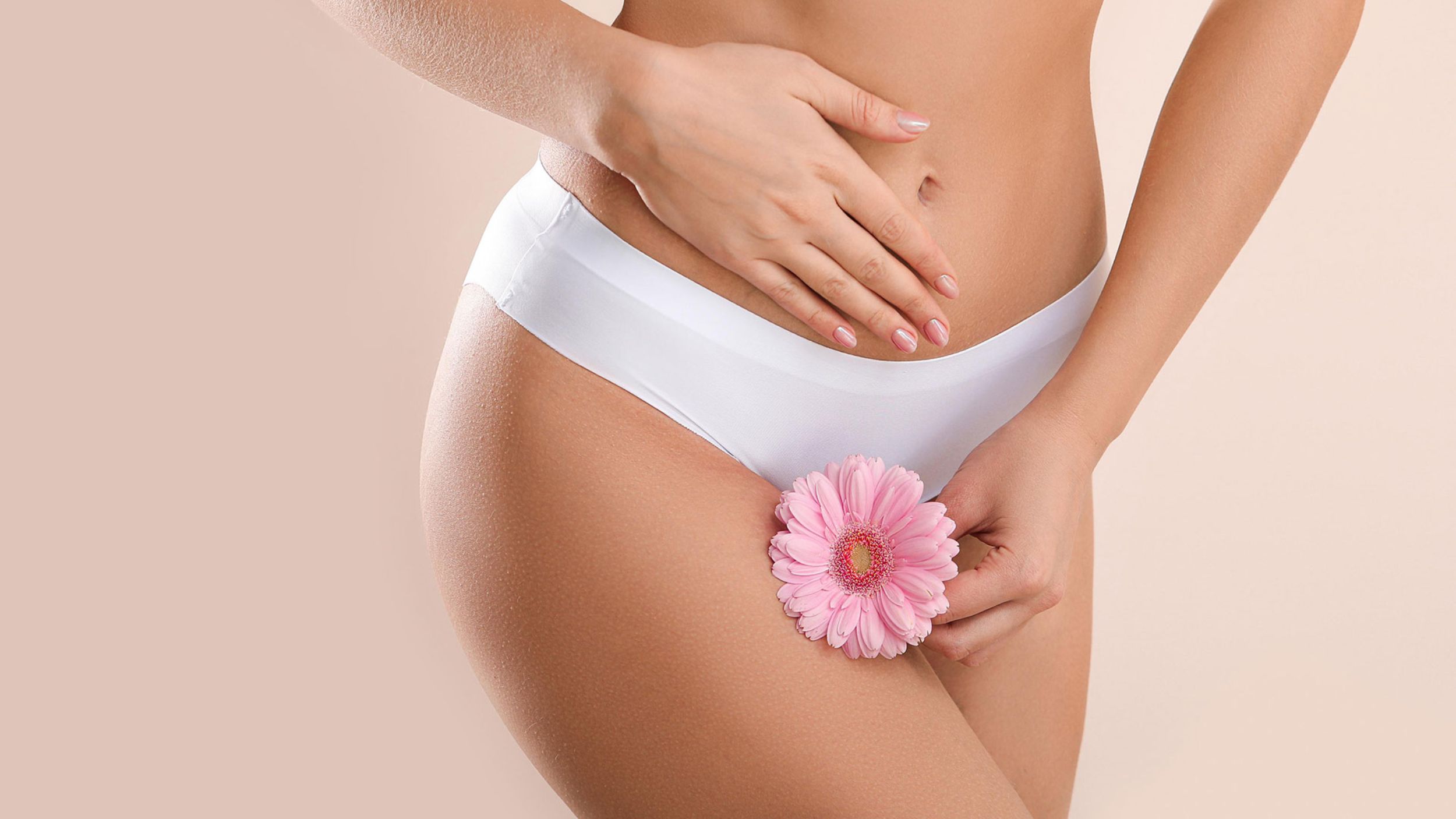 Female body with pink flower in intimate area