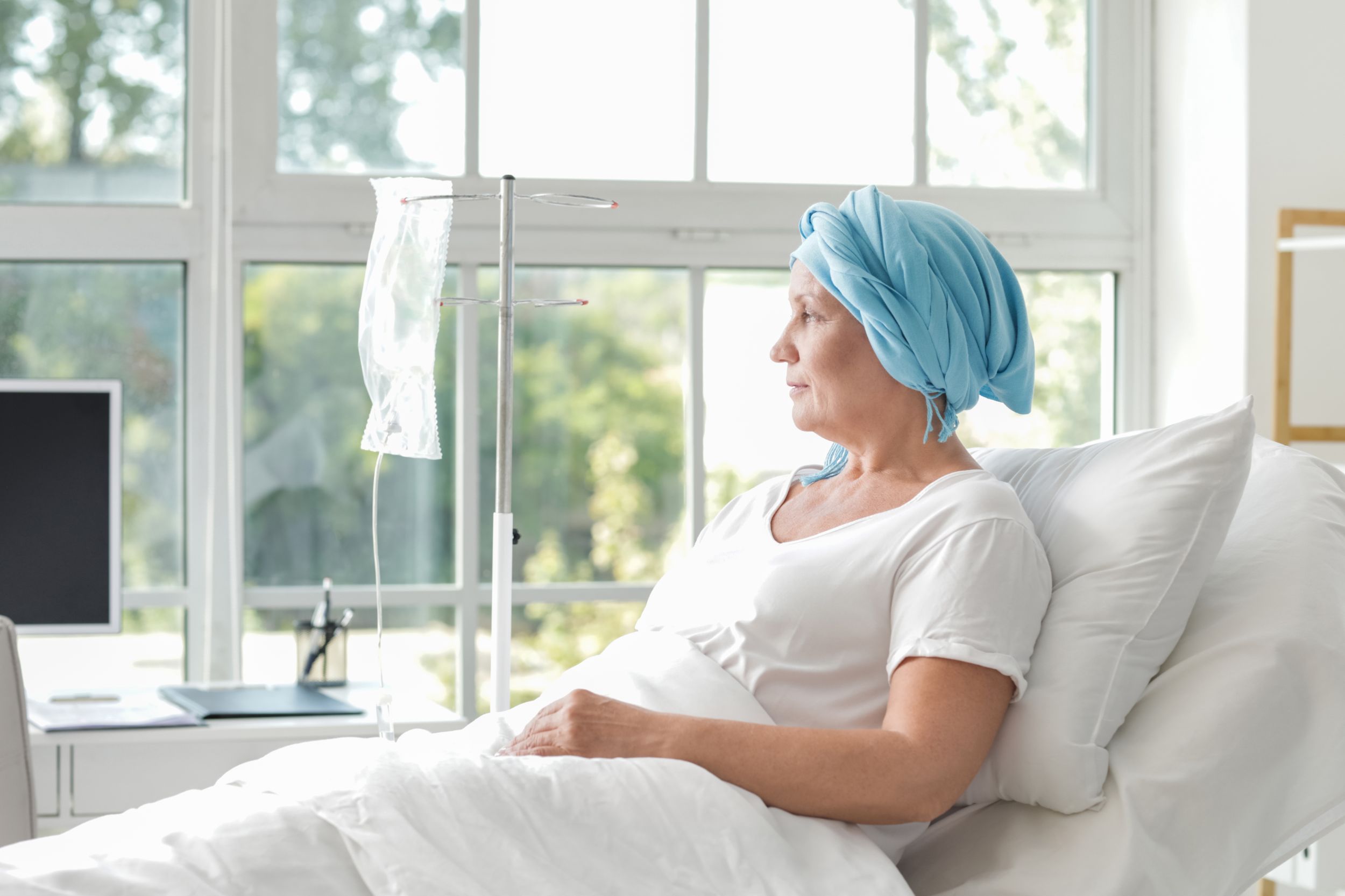 Woman sits in chemotherapy treatment room