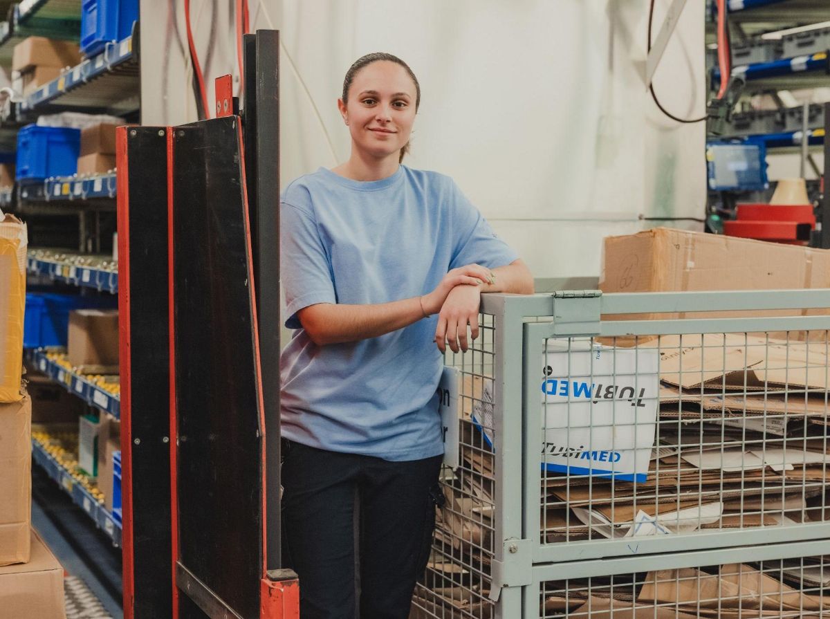 Trainee logistician runs through the warehouse