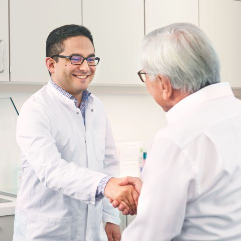 Physician shakes hand with patient