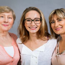 Portrait of 3 generations of women smiling side by side