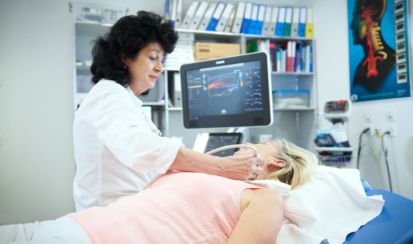 Physician performs neurovascular ultrasound examination on patient